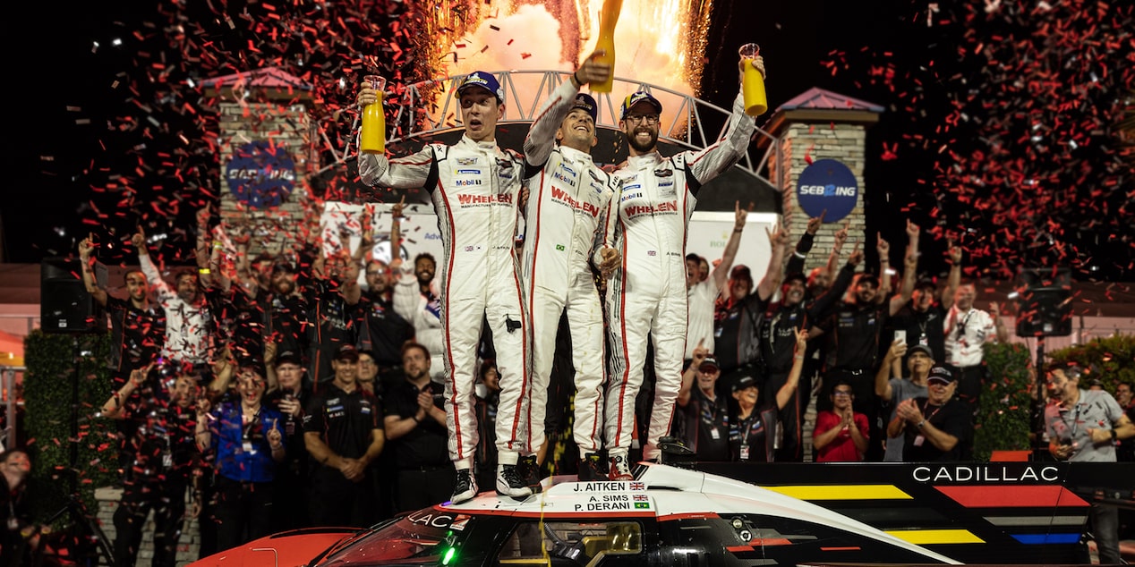 Cadillac Racing Drivers Celebrate a Sebring Win with the Crew Cheering in the Background