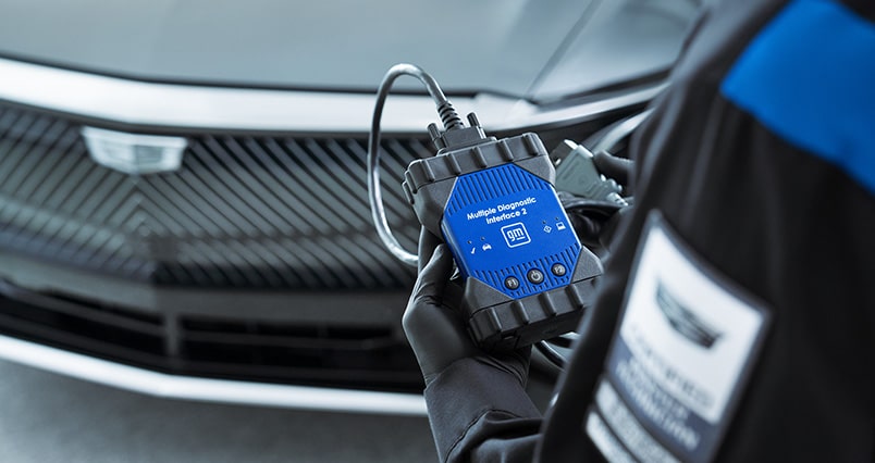 Cadillac Certified Service Technician Using a Multiple Interface Diagnostic Tool Connected to a Cadillac LYRIQ