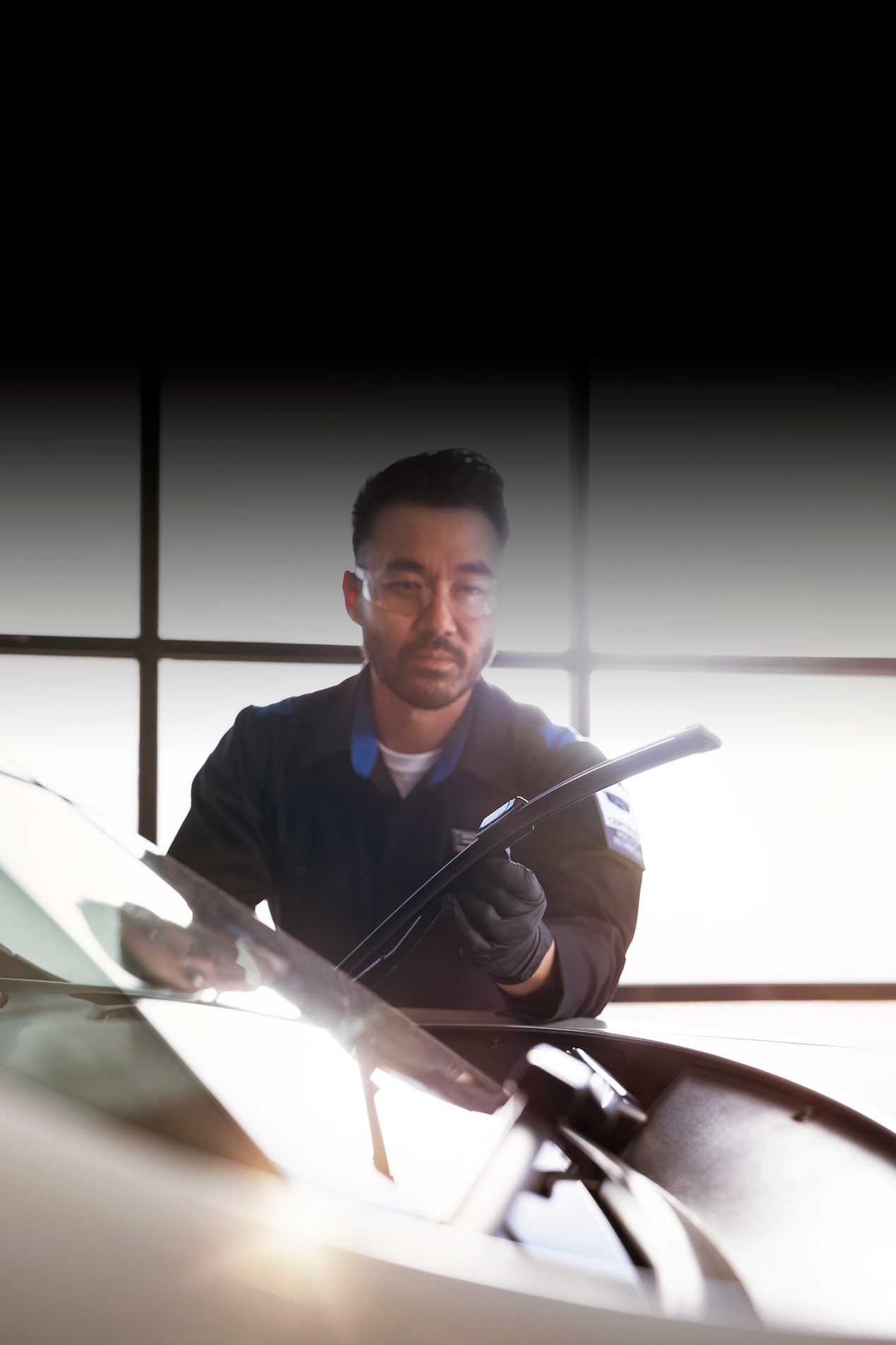 Cadillac Certified Service Technician Inspecting Windshield Wipers on a Vehicle