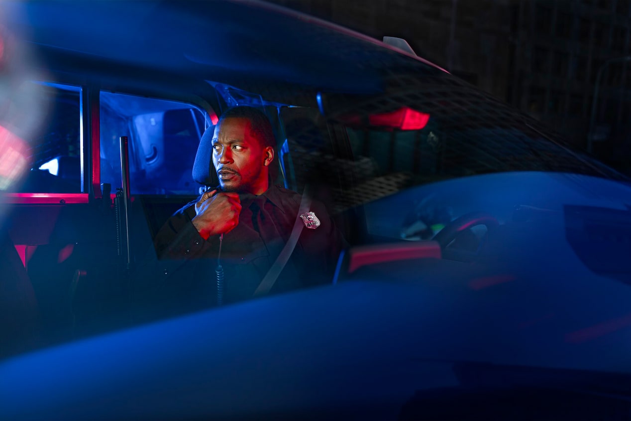 Dashboard View of an Officer in His Vehicle Responding to His Radio