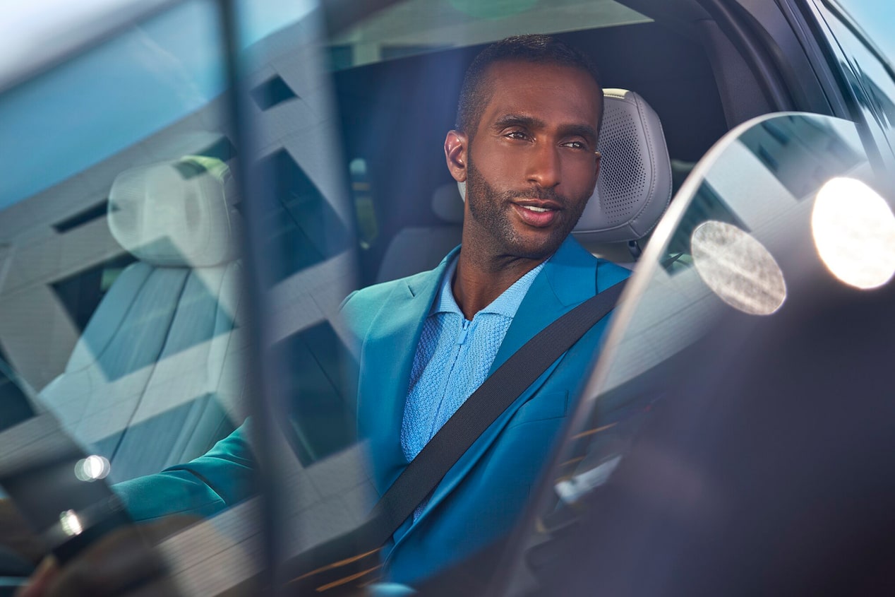 Focused View of a Man Driving a Cadillac and Looking Out the Window