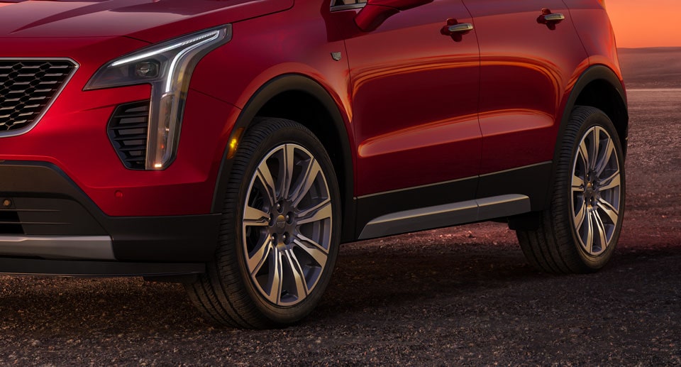 Close-up of Wheels on a Cadillac SUV Parked on Gravel Video Thumbnail