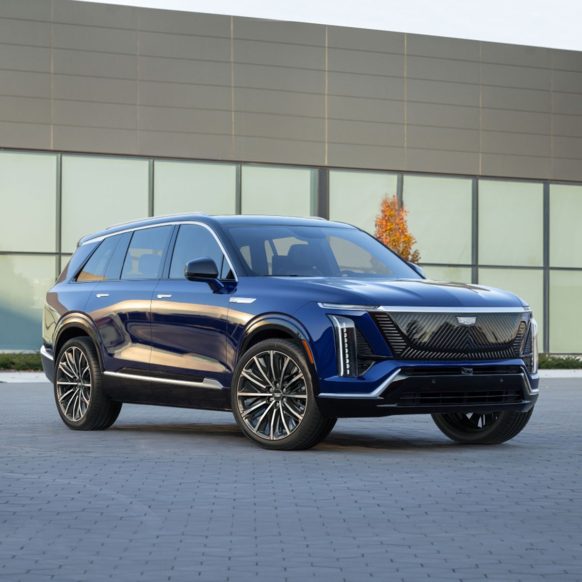 Front View of a 2026 Blue Cadillac VISTIQ Parked in Front of a Modern Building