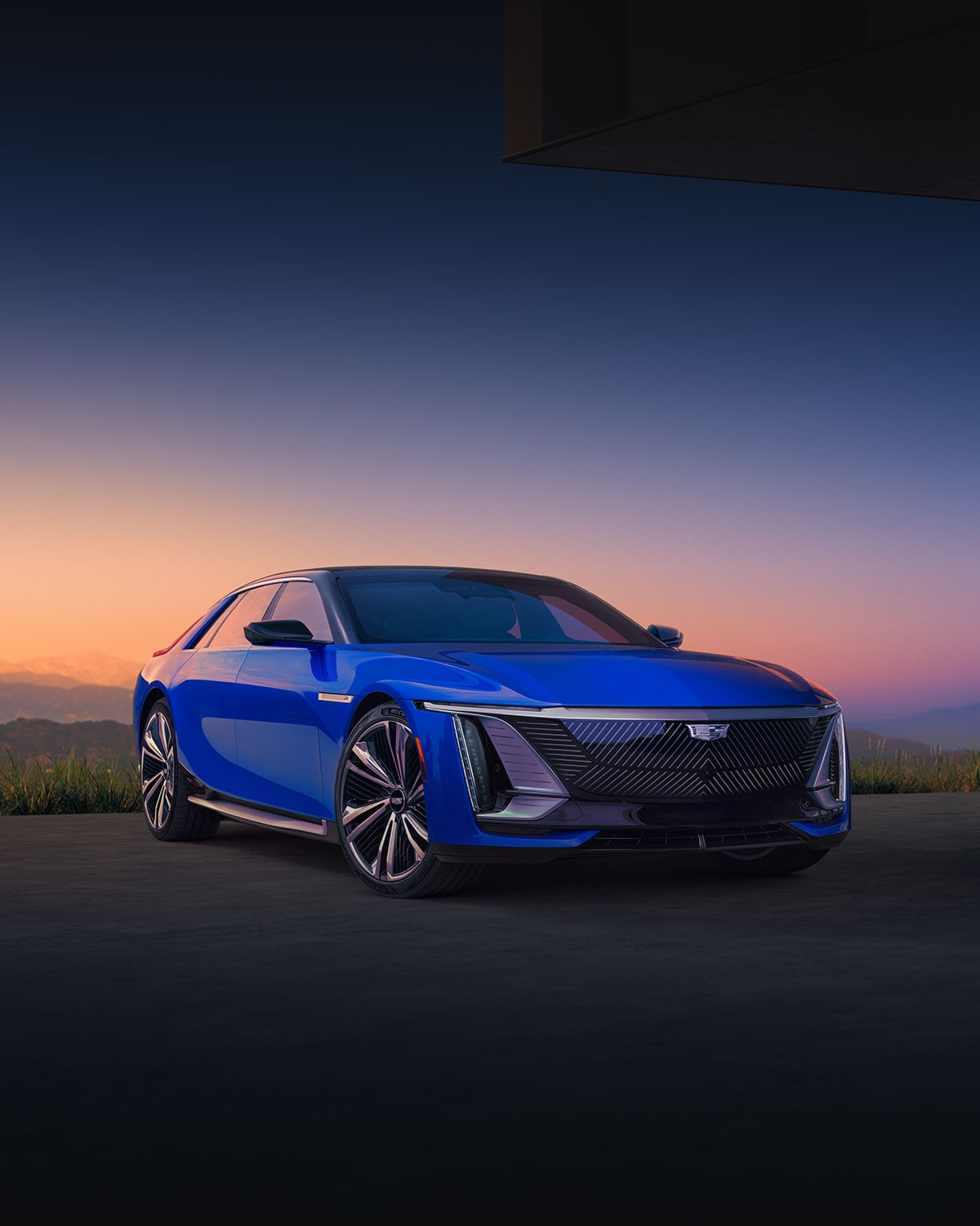 Three-quarter View of a Blue Cadillac CELESTIQ Under a Mountain Sunset