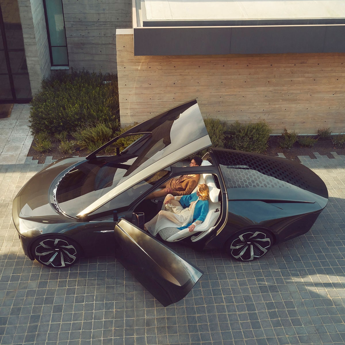 Overhead Shot of a Couple Sitting Inside of aBlack Cadillac Concept Vehicle