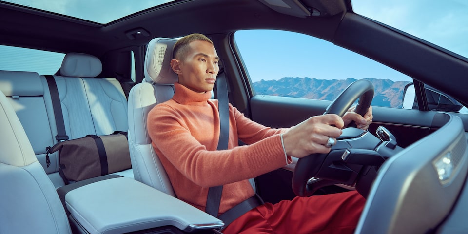 A Man Drives His LYRIQ with Both Hands on the Steering Wheel