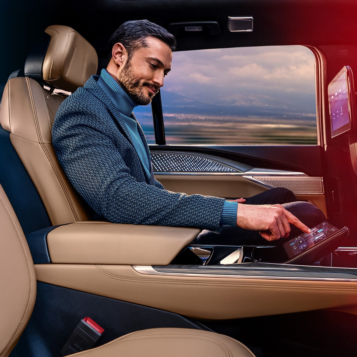 Man Utilizing Rear Seat Entertainment Features Inside the 2025 Cadillac Escalade IQ