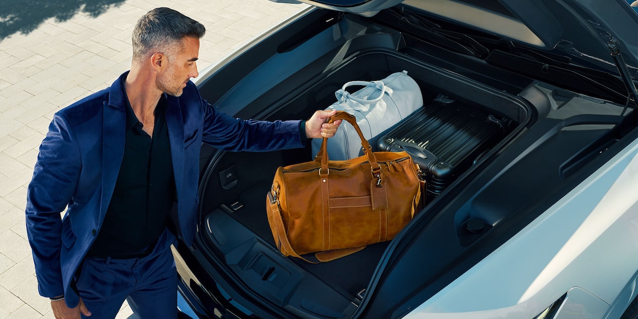 Man Placing His Bags in the 2025 Cadillac Escalade IQ etruck