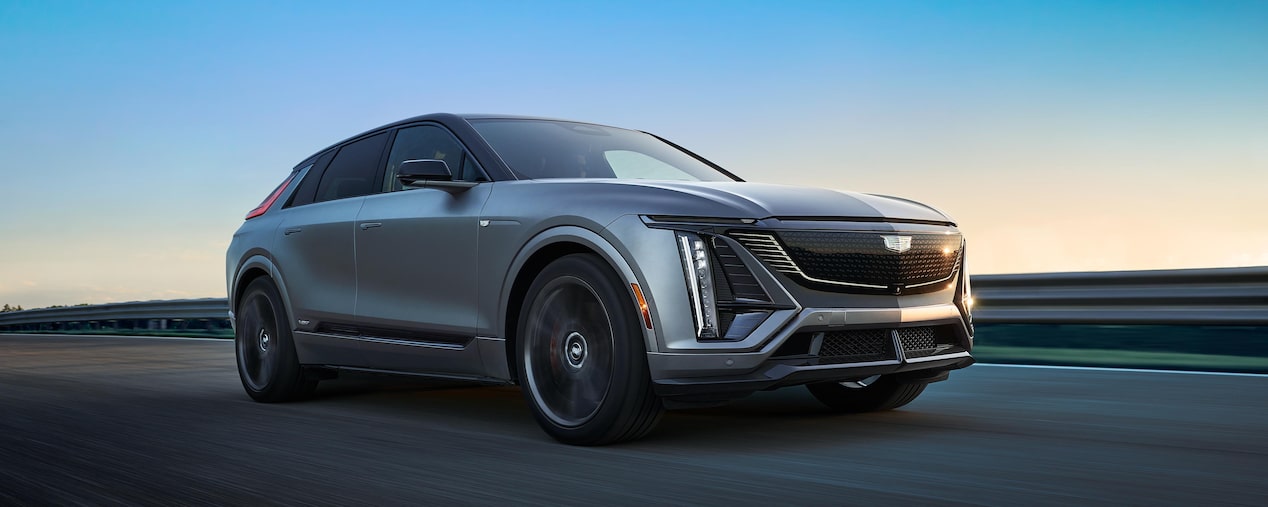 Low Three-Quarters View of the 2026 Cadillac LYRIQ-V Driving Down the Road