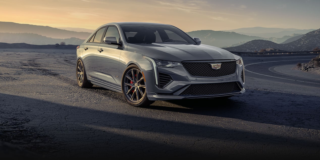 Three-quarter View of a Silver 2024 Cadillac CT4-V Parked on the Side of a Mountain Road