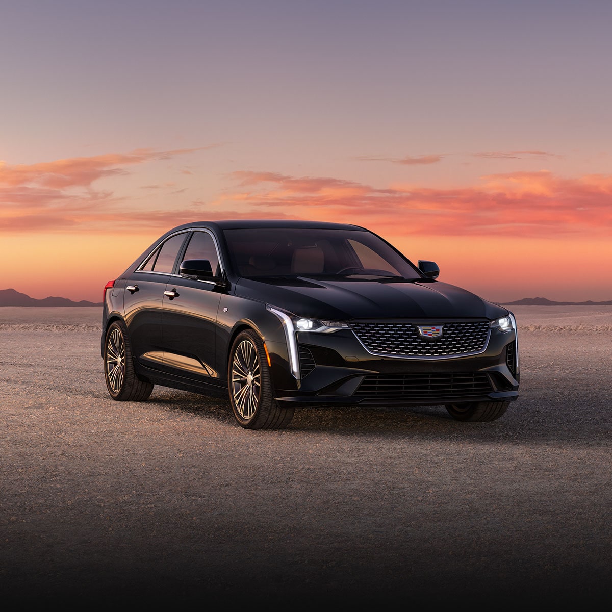 Three-quarter View of a 2024 Cadillac CT4 Parked in the Open Desert During Sunset