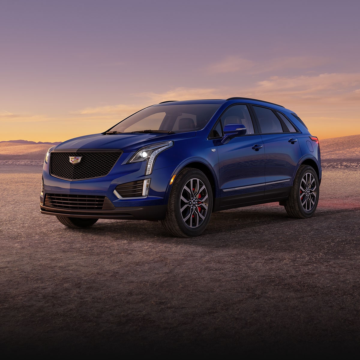 Three-quarter View of a Blue 2024 Cadillac XT5 Parked in the Desert